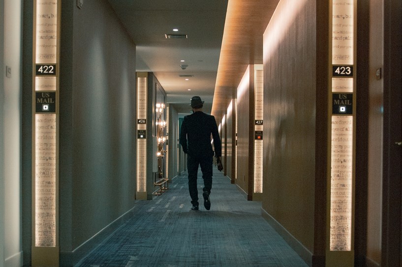 Man walking through hotel corridor